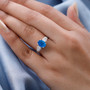 neon apatite and diamond baguette ring in 10k white gold worn on a hand