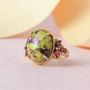 close up of atlantisite and rhodolite garnet ring in 18k yellow gold over sterling silver