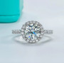 close up of round halo moissanite ring in rhodium over sterling silver