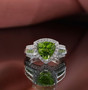close up of peridot and white zircon trillion halo ring in rhodium over sterling silver