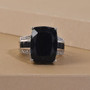 angled studio view of black tourmaline, black spinel, and white zircon ring showing the deep faceted luster of the center stone and high-polish rhodium finish angled studio view of black tourmaline, black spinel, and white zircon ring showing the deep faceted luster of the center stone and high-polish rhodium finish