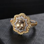 turkish diaspore double halo ring in yellow gold and rhodium displayed on black background showing brilliance and color change turkish diaspore double halo ring in yellow gold and rhodium displayed on black background showing brilliance and color change