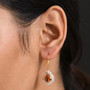 madeira citrine kite cut dangle earrings with moissanite halo and baguette accents in 18k yellow gold over sterling silver worn on the ear