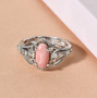 studio display of peach opal and white zircon ring highlighting its elegant scrollwork design and warm peach tone center stone studio display of peach opal and white zircon ring highlighting its elegant scrollwork design and warm peach tone center stone