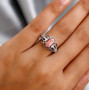 peach opal and white zircon ring in rhodium over sterling silver worn on a hand
