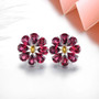 close up of rhodolite garnet and citrine flower cluster earrings in rhodium over sterling silver