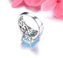 close up of natural sky blue topaz and rhodolite garnet ring in rhodium over 925 sterling silver
