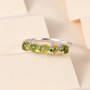 studio display of vesuvianite five stone band ring highlighting natural green hue of stones and smooth rhodium-plated finish studio display of vesuvianite five stone band ring highlighting natural green hue of stones and smooth rhodium-plated finish