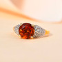 Angled display showing the fiery orange Madeira Citrine with leaf-inspired White Zircon shoulders set in polished yellow gold over sterling silver