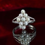 freshwater pearl cluster ring in rhodium over sterling silver shown in a lifestyle photo
