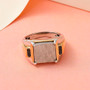 meteorite and black diamond men’s ring displayed on pink background, highlighting polished gold and silver contrast and geometric meteorite pattern
