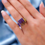 ametrine amethyst and citrine open work euro shank ring in two-tone rhodium and 18k yellow gold over sterling silver worn on a hand