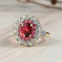 rubellite tourmaline and diamond halo ring displayed on neutral surface showing vivid pink-red gemstone and radiant sparkle