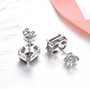 full view of garnet white zircon and emerald cut halo stud earrings in rhodium over sterling silver