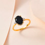 close up of black tourmaline and white zircon accents oval solitaire ring in 18k yellow gold over sterling silver