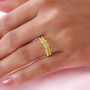 yellow tourmaline 5 stone band ring in 10k yellow gold worn on a hand
