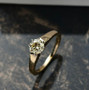 lab yellow diamond round solitaire wedding ring in 10k yellow gold shown in a lifestyle photo
