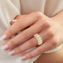natural yellow and white diamond baguette and round cluster band ring in 14k yellow gold worn on a hand