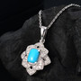 close up of turquoise and zircon ring and pendant necklace jewelry set in rhodium over sterling silver