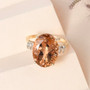 honey scapolite and diamond oval solitaire ring in 10k yellow gold shown in a lifestyle photo