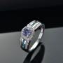 angled view of tanzanite london blue topaz and zircon bypass ring in rhodium over sterling silver