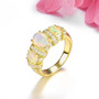 ethiopian opal and white zircon trilogy ring in 18k yellow gold over sterling silver shown in a lifestyle photo