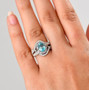 blue zircon and moissanite bypass ring in rhodium over sterling silver shown for size comparison