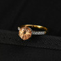 close up of imperial garnet and moissanite round crown solitaire ring in 18k yellow gold over sterling silver