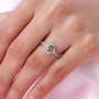 golden tanzanite and white zircon halo ring in rhodium over sterling silver worn on a hand