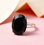 close up of black tourmaline oval solitaire split shank ring in rhodium over sterling silver