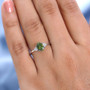 green tourmaline and moissanite ring in rhodium over sterling silver worn on a hand