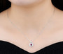 ruby and white zircon necklace in rhodium over 925 sterling silver worn around the neck