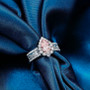 lab pink and white diamond pear halo ring in 14k white and rose gold shown in a lifestyle photo
