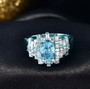 close up of blue zircon and moissanite ring in blue e-coating over sterling silver