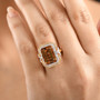 honey scapolite yellow sapphire and diamond halo ring in 10k yellow gold worn on a hand