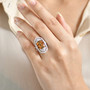 honey scapolite and white zircon ring in rhodium over sterling silver worn on a hand