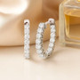 lab diamond round inside outside hoop earrings in rhodium over sterling silver g-h si shown in a lifestyle photo