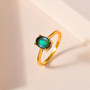ammolite oval solitaire ring in 18k yellow gold over sterling silver shown in a lifestyle photo