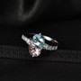 live studio image aquamarine morganite and lab diamond bypass ring on black background