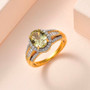 triphane and oval moissanite halo ring in 18k yellow gold over sterling silver shown in a lifestyle photo
