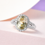triphane and moissanite oval halo split shank ring in rhodium over sterling silver shown in a lifestyle photo