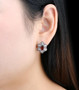 garnet and white zircon earrings in rhodium over 925 sterling silver worn on the ear