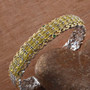 yellow opal and chrome diopside cluster cuff bracelet in two-tone 18k yellow gold and rhodium over sterling silver shown in a lifestyle photo