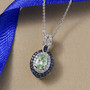 tsavorite garnet sapphire and zircon halo pendant necklace in rhodium over sterling silver shown in a lifestyle photo