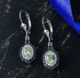 tsavorite garnet sapphire and zircon halo earrings in rhodium over sterling silver shown in a lifestyle photo