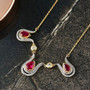 ruby (ff) and white zircon tulip inspired necklace in 18k yellow gold over sterling silver5 shown in a lifestyle photo