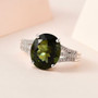 moldavite and diamond triple shank ring in rhodium over sterling silver shown in a lifestyle photo