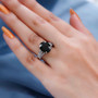 moldavite and diamond triple shank ring in rhodium over sterling silver worn on a hand