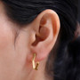 10k yellow gold hexagon hoop earrings worn on the ear