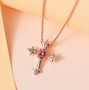 pink apatite and white zircon cross pendant necklace in 18k rose gold over sterling silver shown in a lifestyle photo